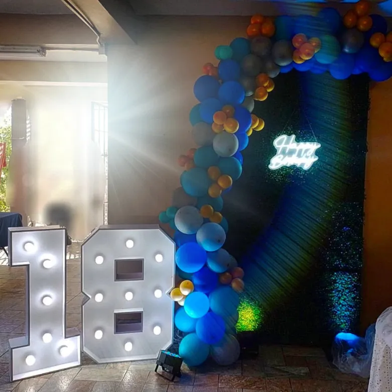 Blue and gold balloon garland, neon happy birthday sign and light-up 18 marquee numbers